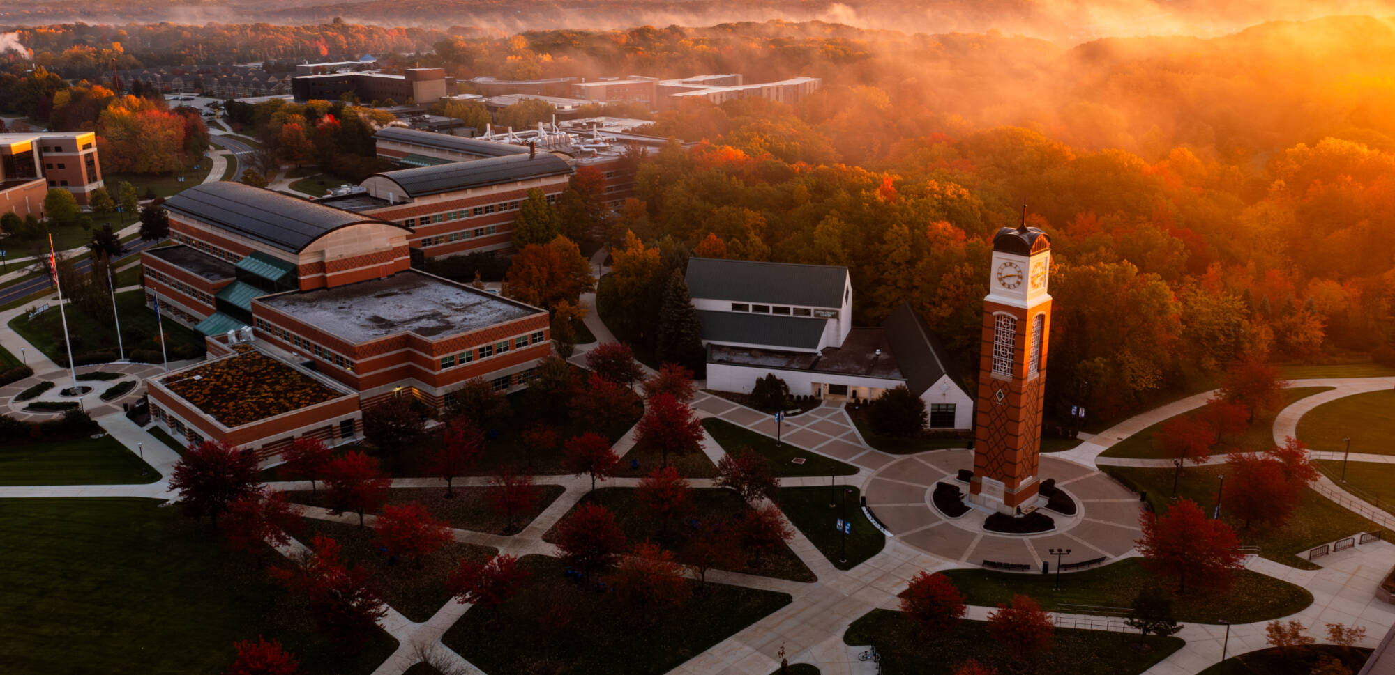 carillon tower, cook-dewitt, and student services building in autumn with some fog